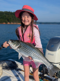 Love that smile when she caught a Lake Lanier Striped Bass